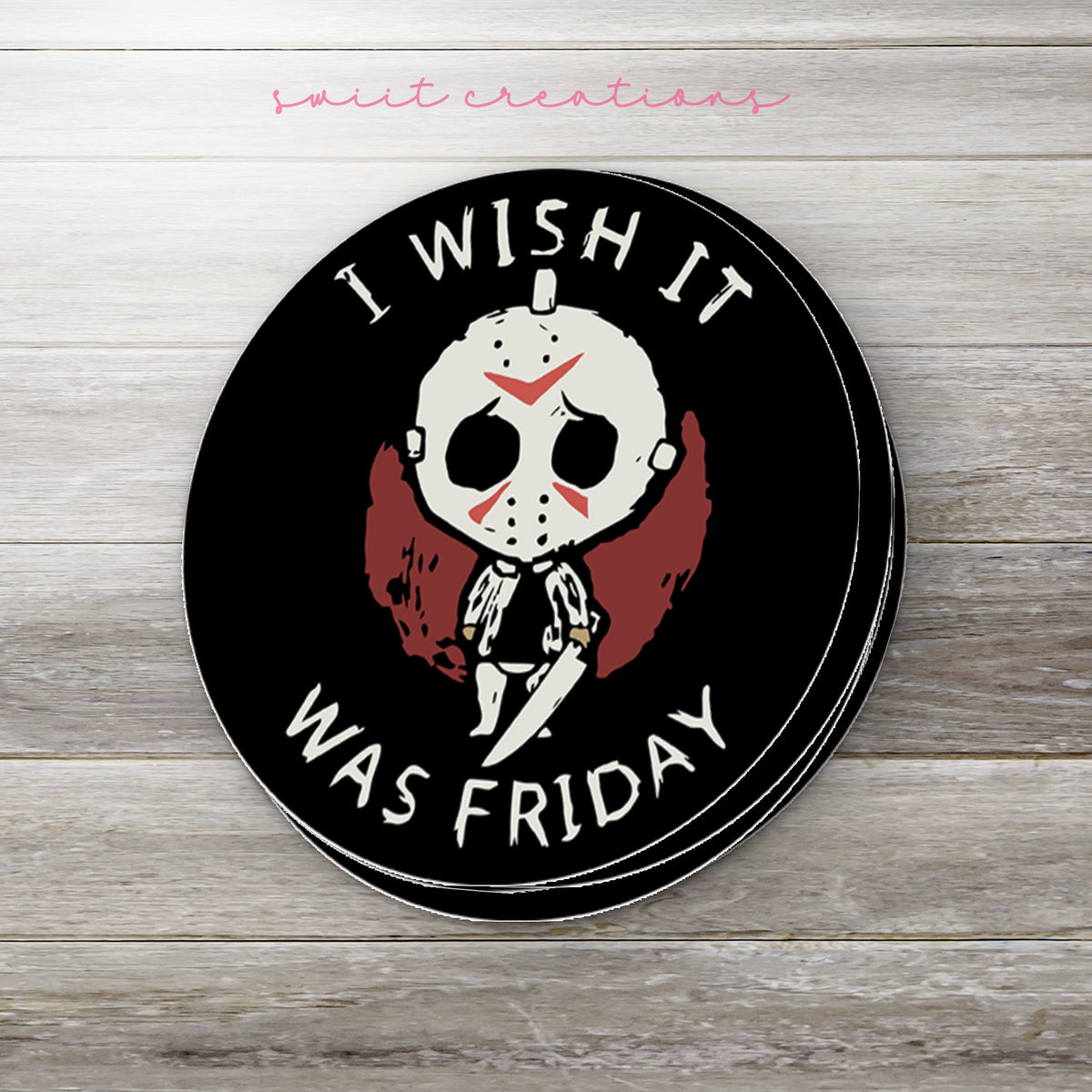 Stack of I Wish It Was Friday glossy stickers on a gray wood table
