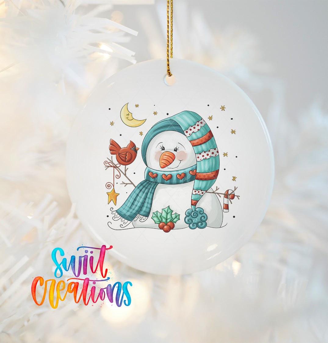 A white ornament featuring a snowman with a scarf, a bird, and other winter-themed elements.
