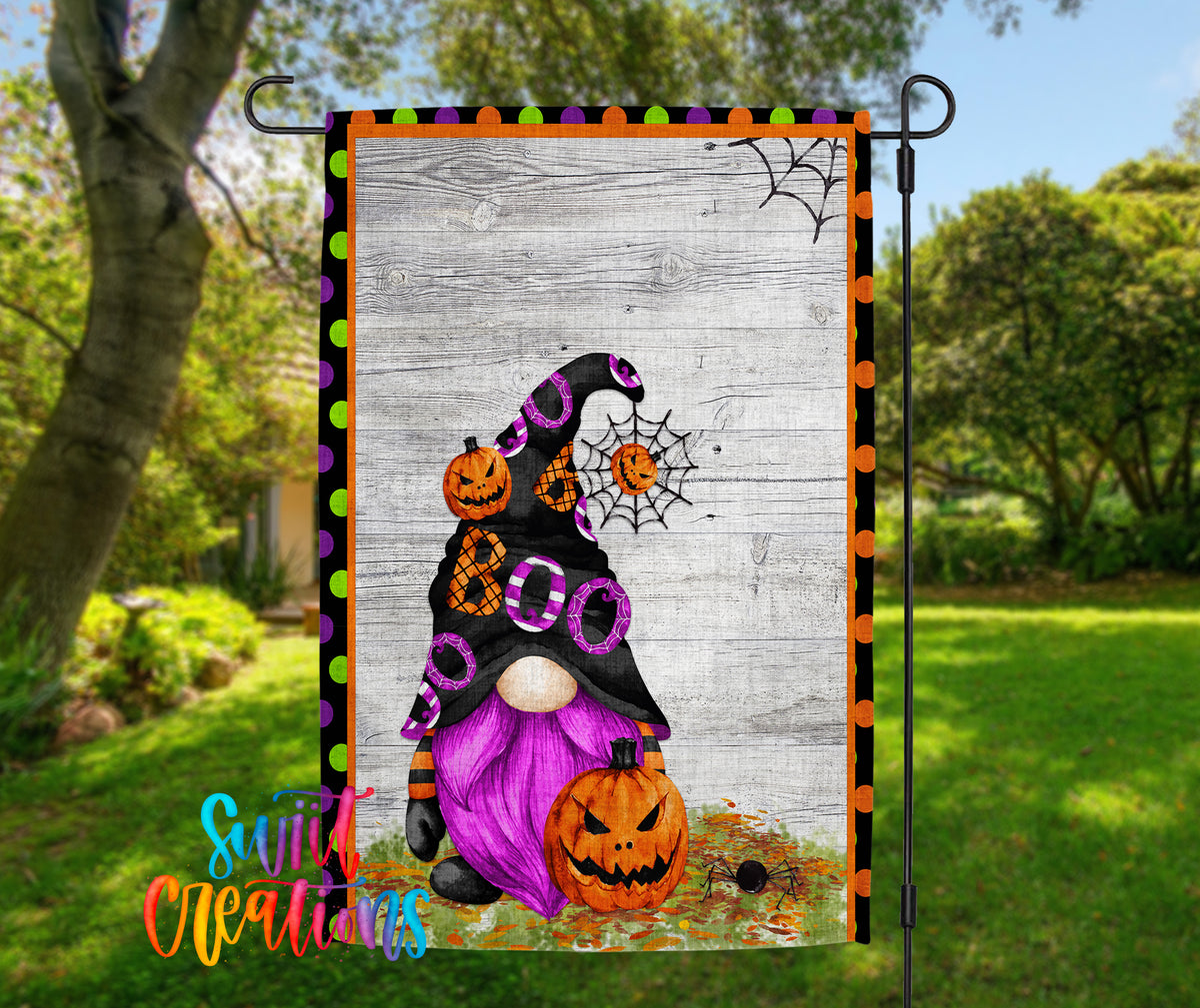 A Halloween-themed garden flag featuring a purple gnome holding a carved pumpkin and a spider web.