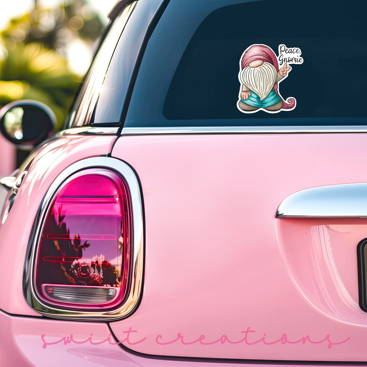 Peace Gnomie sticker on the back window of a pink car