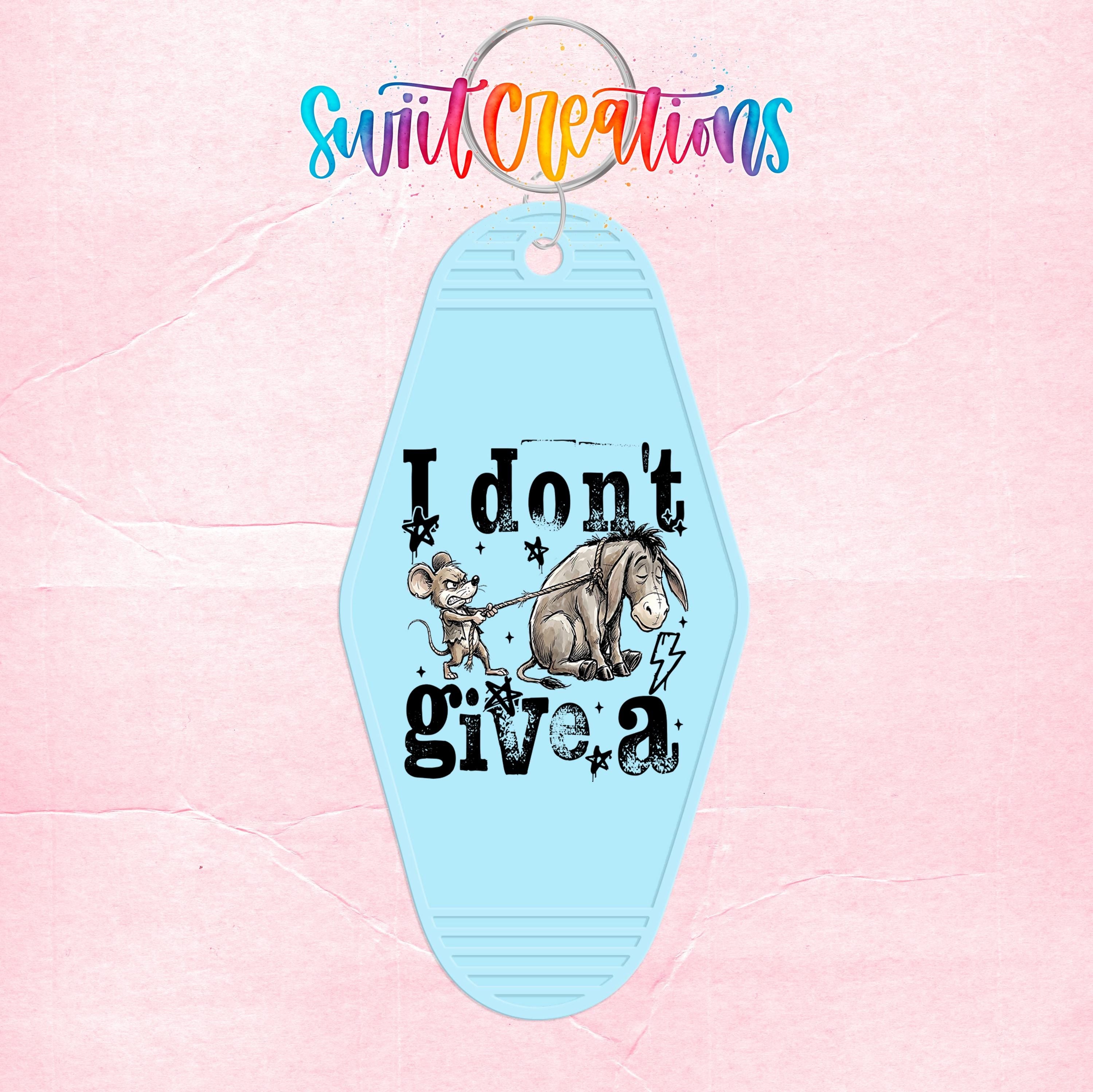 A keychain with a light blue color and a design featuring a cartoon character and the text "I don't give a"