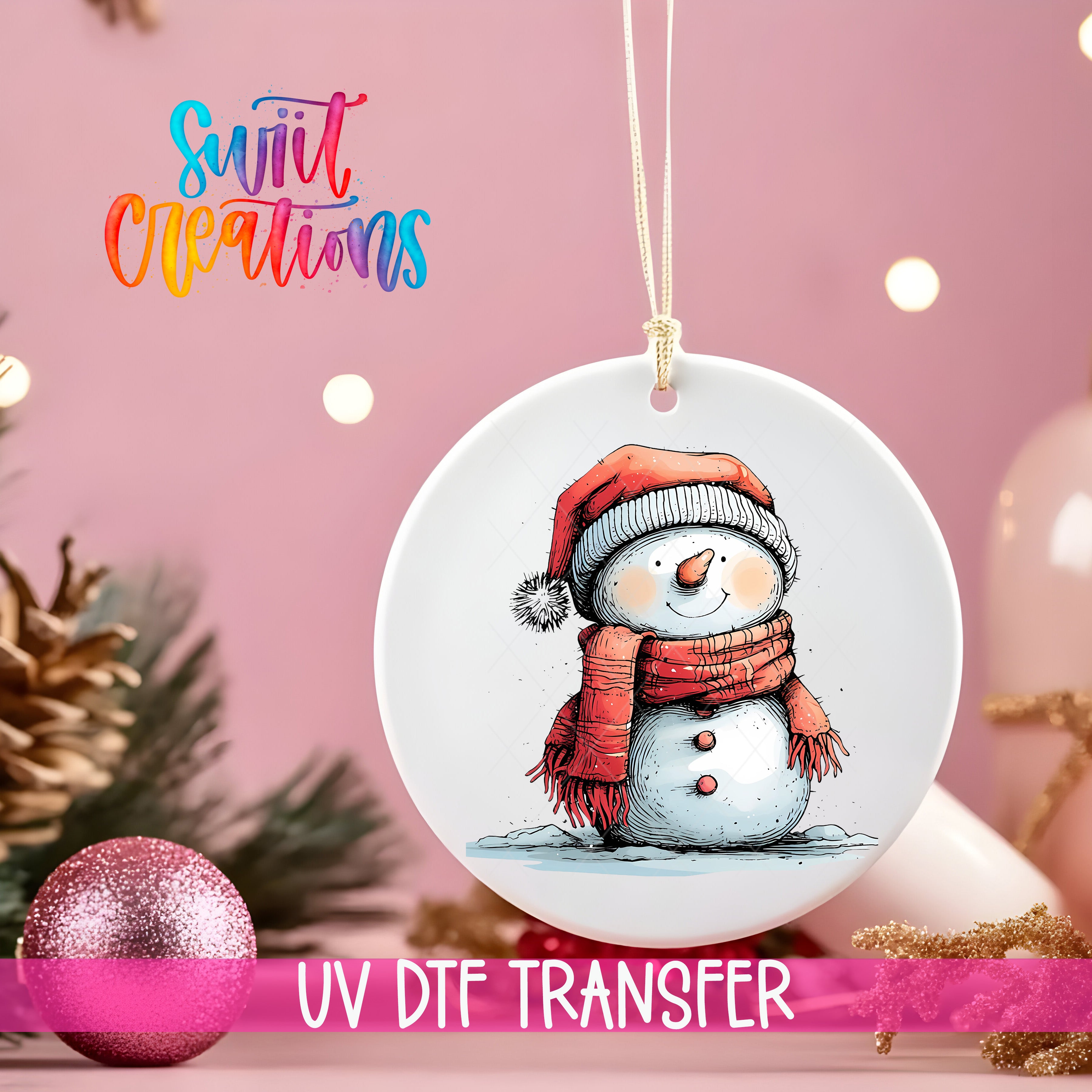 A white ceramic ornament with a snowman illustration is hanging on a string, surrounded by Christmas decorations and a pink background.
