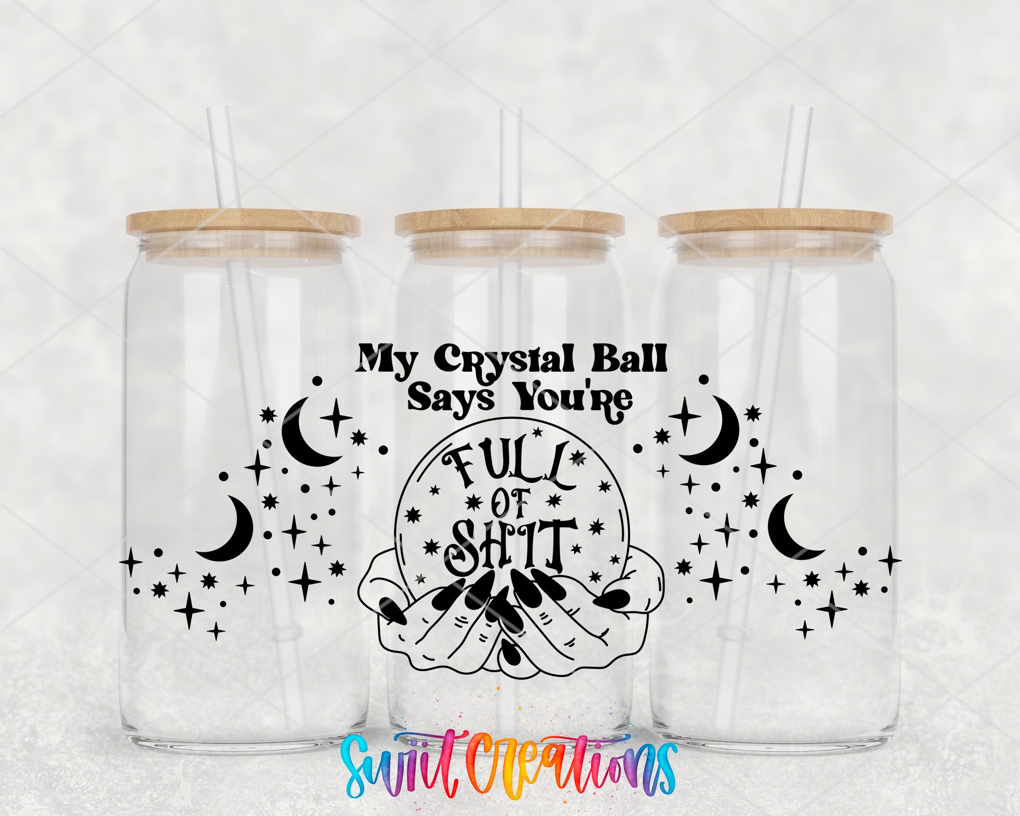 three clear glass tumblers with wooden lids, each adorned with a black and white design depicting a crystal ball surrounded by stars and crescent moons. The text "My Crystal Ball Says You're FULL OF SALT" is prominently displayed on the tumblers, along with the phrase "Swift Creations" at the bottom.