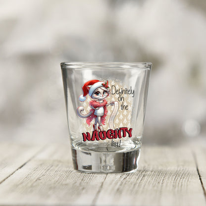 Close-up of the Definitely on the Naughty List Christmas UV DTF transfer on a clear shot glass