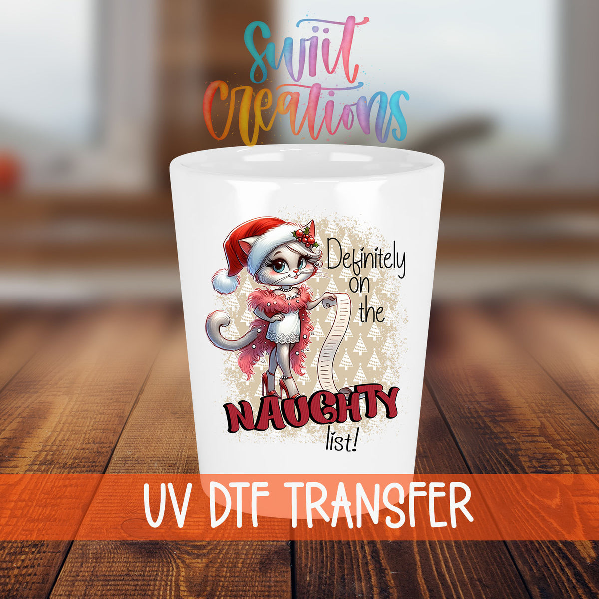 Definitely on the Naughty List Christmas shot glass transfer on a white shot glass on a wooden table