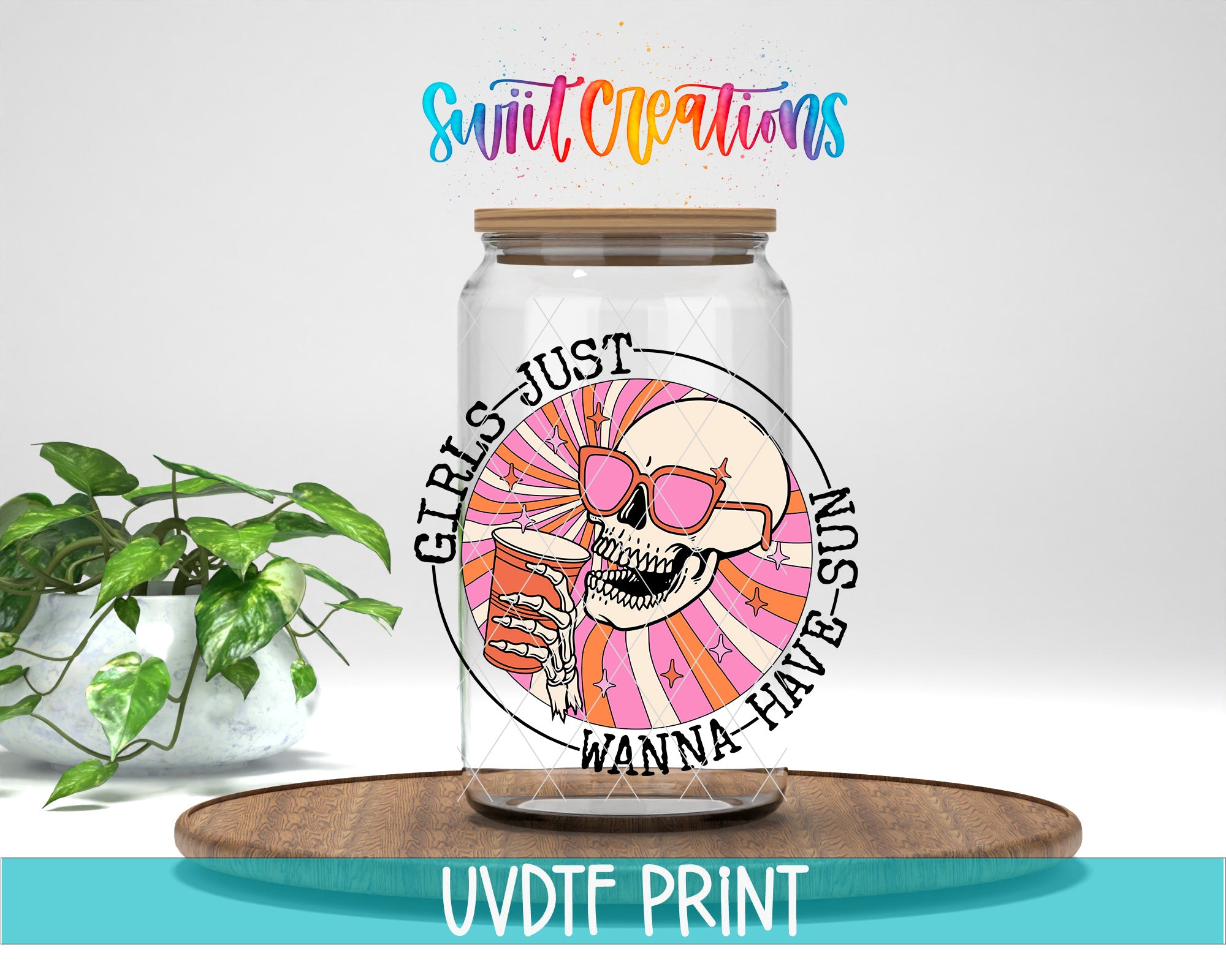 A glass jar with a skull wearing sunglasses and holding a drink, surrounded by a colorful design, placed on a wooden surface.