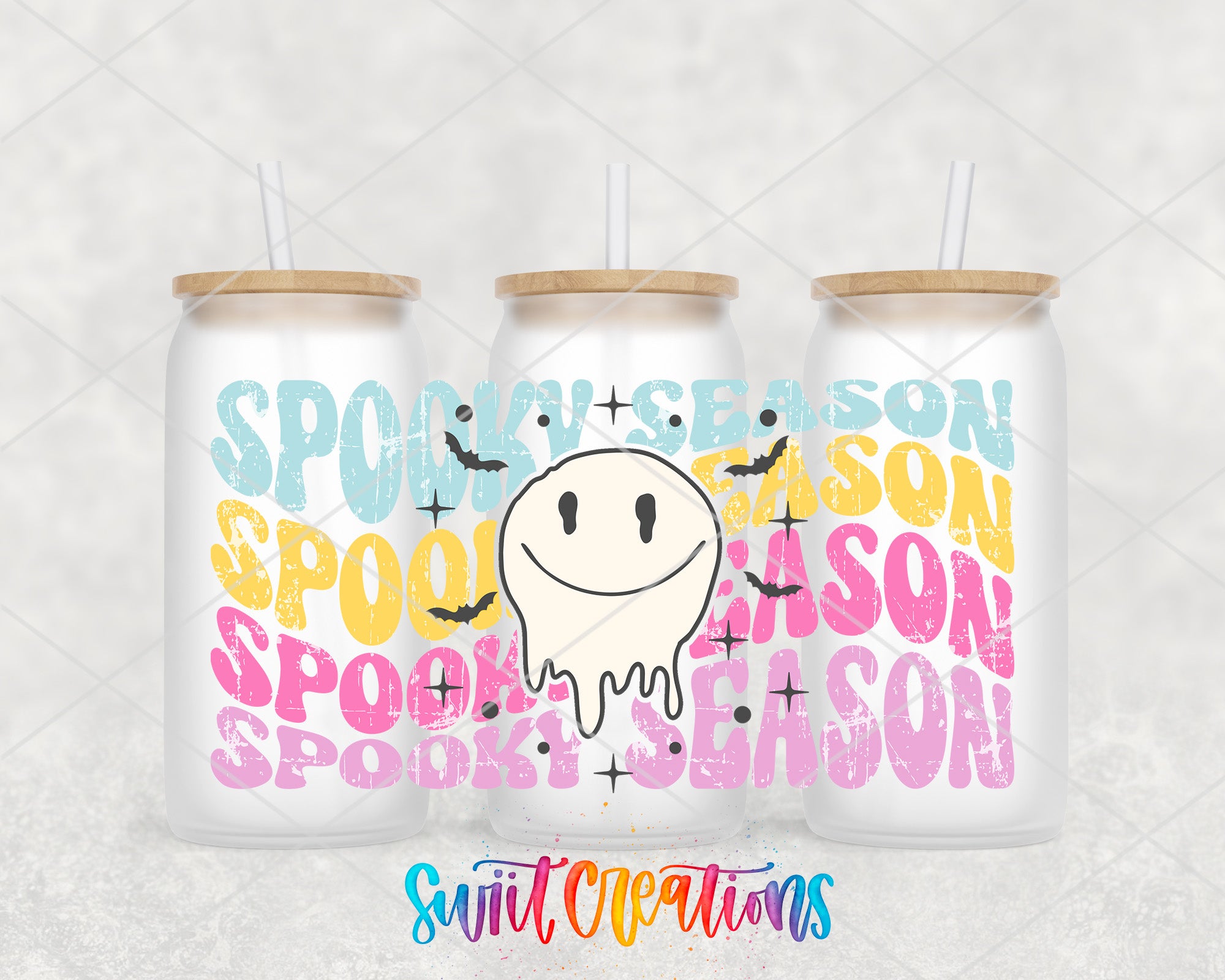 three white cans with a Halloween-themed design, including a smiling ghost and the text "SPOOKY SEASON" in various colors.
