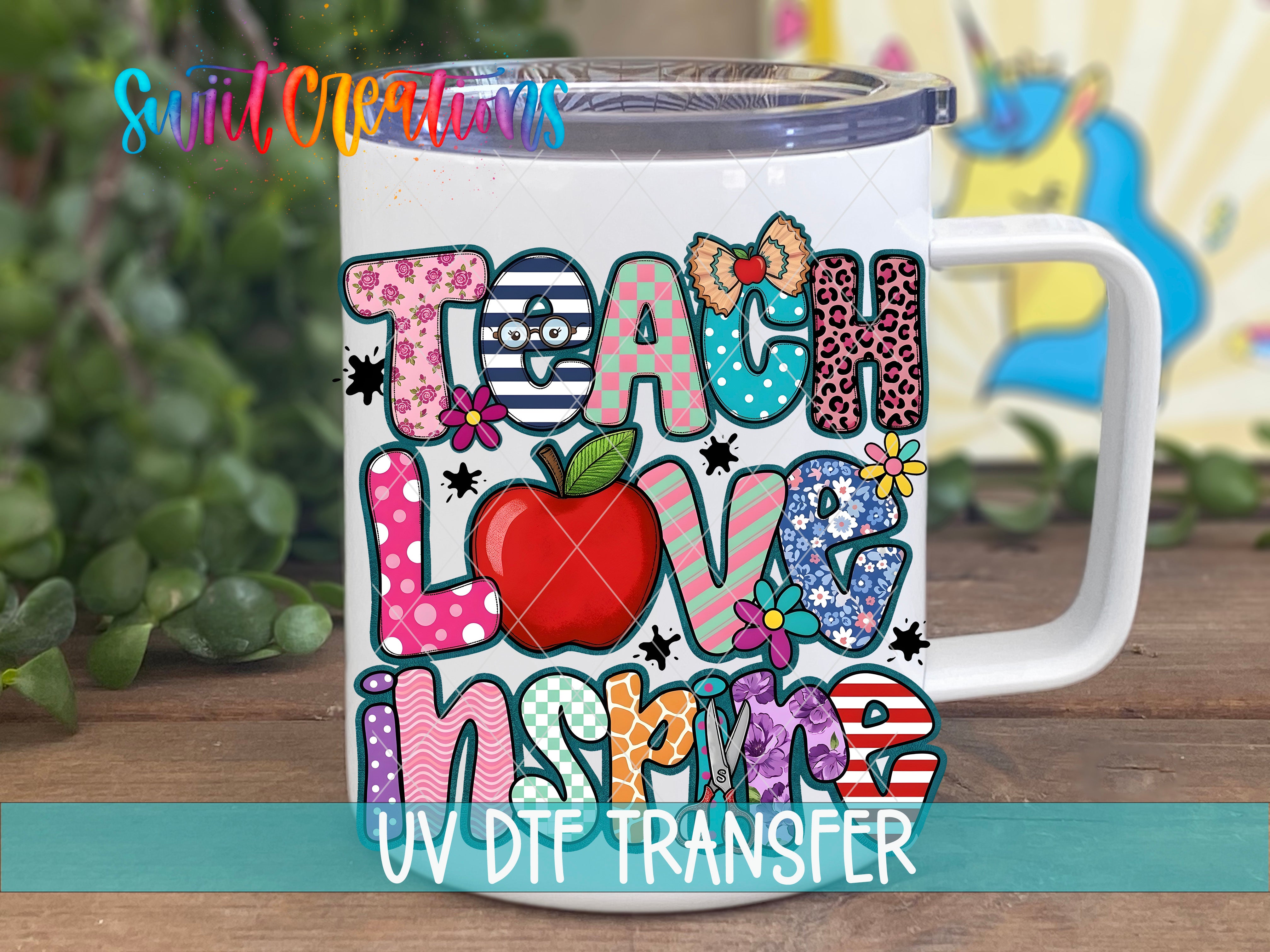 A colorful mug with the text "Teach Love Inspire" printed on it, surrounded by various decorative elements such as flowers, leaves, and a rainbow.