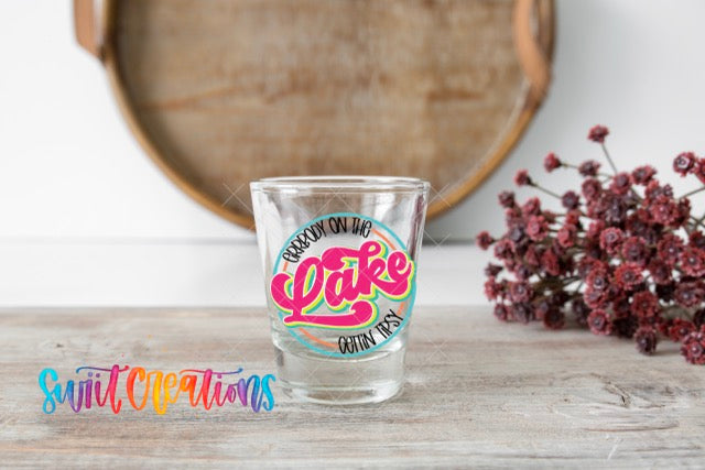 a shot glass sitting on top of a wooden table