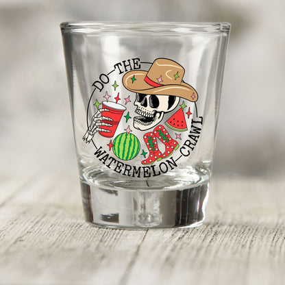 Do The Watermelon Crawl shot glass UV DTF transfer with cowboy skeleton, watermelon, and boots on a clear shot glass