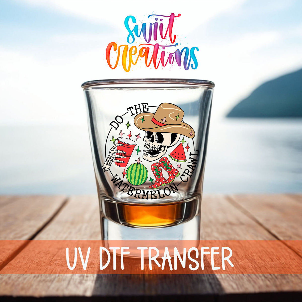Do The Watermelon Crawl shot glass UV DTF transfer on a filled shot glass on a dock by the water