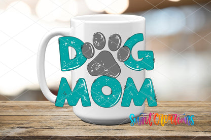 Dog Mom teal letters and paw print UV DTF transfer on a white ceramic coffee mug