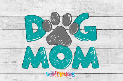 Dog Mom teal letters and paw print UV DTF transfer artwork on a white wood background
