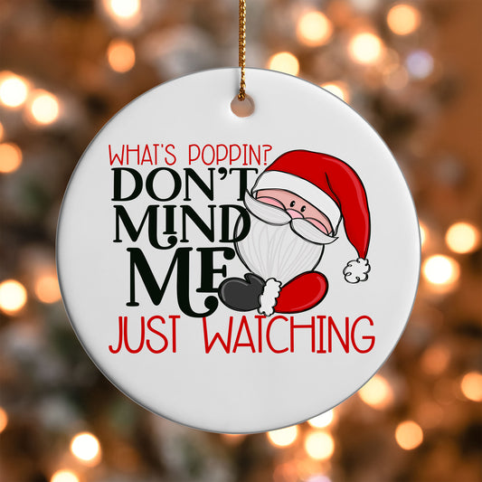 Don't Mind Me Just Watching Santa ornament UV DTF transfer on a round white ornament with a bokeh light background