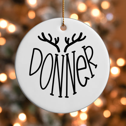 Donner Reindeer Name ornament UV DTF transfer on a round white ornament with a bokeh light background