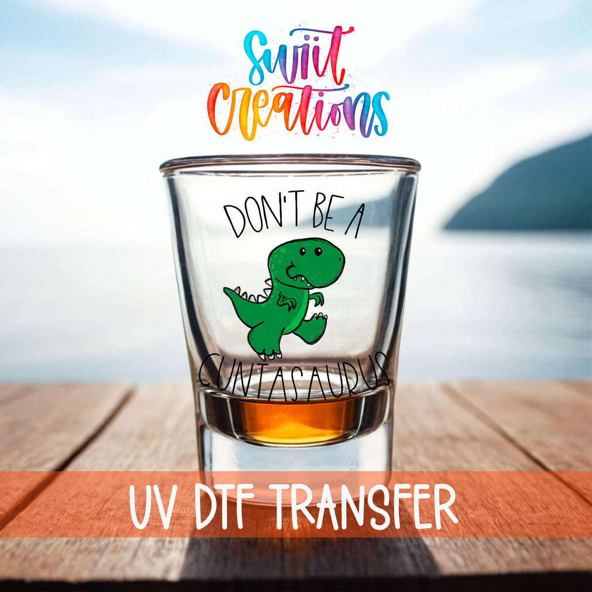 Don't Be a Cuntasaurus shot glass UV DTF transfer on a filled shot glass on a dock by the water