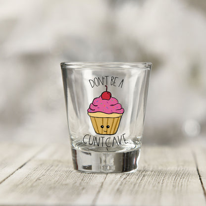 Close-up of the Don't Be a Cuntcake UV DTF transfer on a clear shot glass