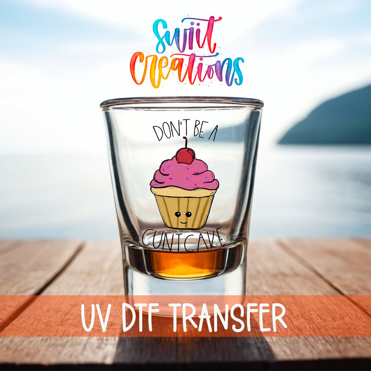 Don't Be a Cuntcake shot glass UV DTF transfer on a filled shot glass on a dock by the water
