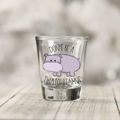 Close-up of the Don't Be a Twatopotamus UV DTF transfer on a clear shot glass