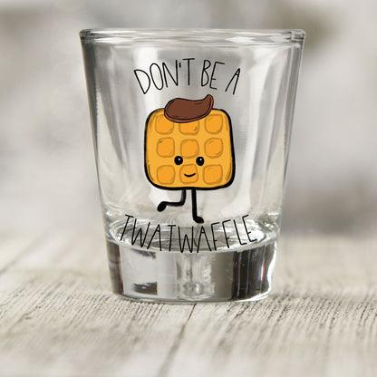 Don't Be a Twatwaffle shot glass UV DTF transfer with cartoon waffle character on a clear shot glass