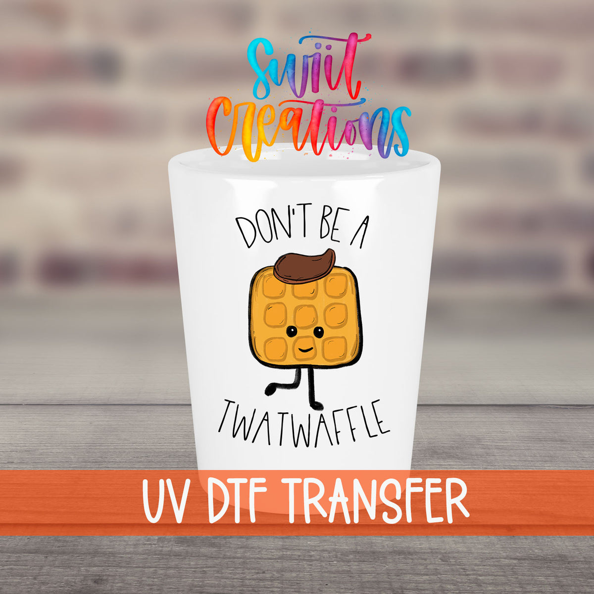 Don't Be a Twatwaffle UV DTF transfer on a white shot glass in front of a brick wall