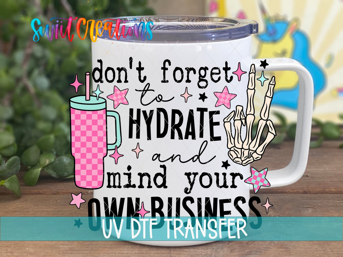 Hydrate and Mind Your Own Business UV DTF transfer on a white stainless steel mug with a lid