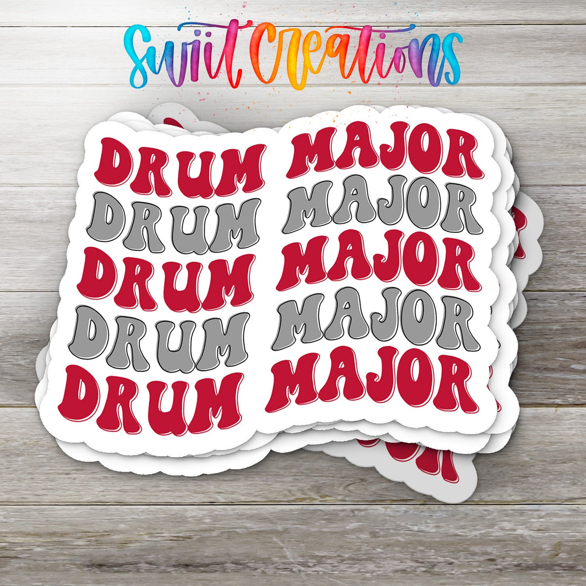 Stack of Red and Gray Drum Major glossy stickers on a gray wood table