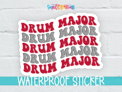 Red and Gray Drum Major sticker on a white brick background with a waterproof sticker banner