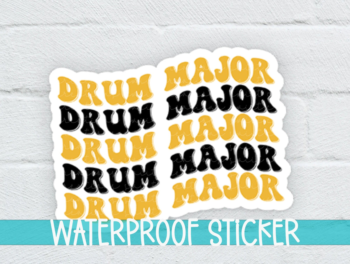 Black and Gold Drum Major sticker on a white brick background with a waterproof sticker banner