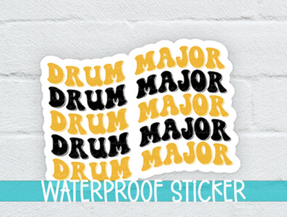 Black and Gold Drum Major sticker on a white brick background with a waterproof sticker banner