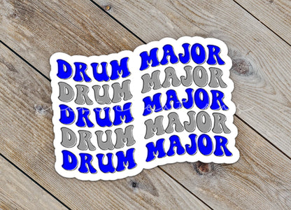 Close-up of the Blue and Silver Drum Major sticker on rustic wood