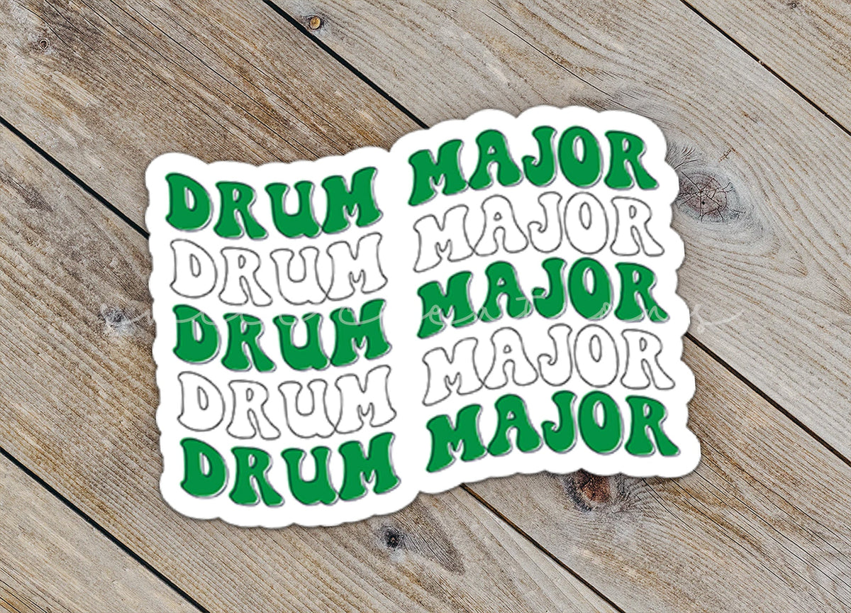 Close-up of the Green and White Drum Major sticker on rustic wood