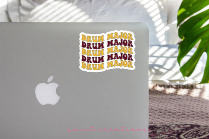 Maroon and Gold Drum Major sticker on the lid of a silver laptop