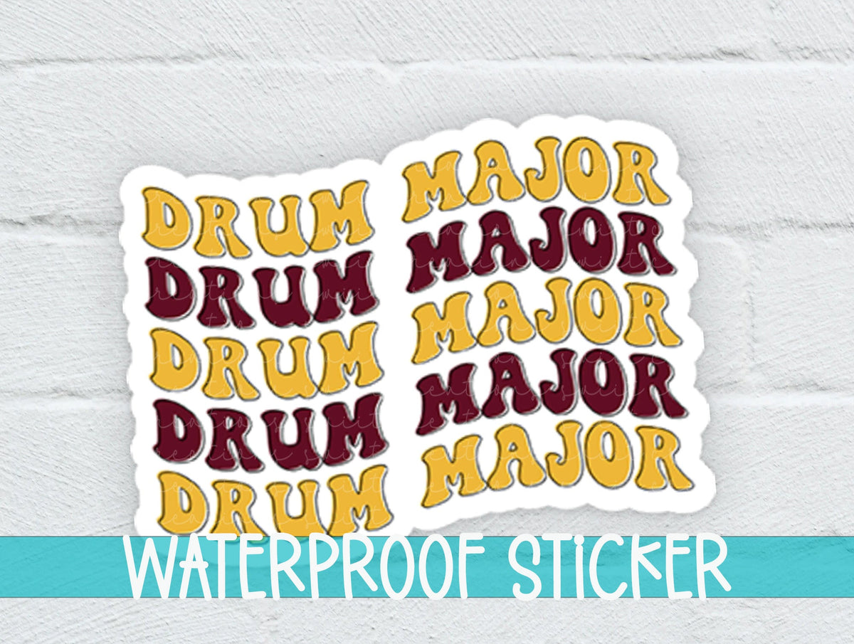 Maroon and Gold Drum Major sticker on a white brick background with a waterproof sticker banner