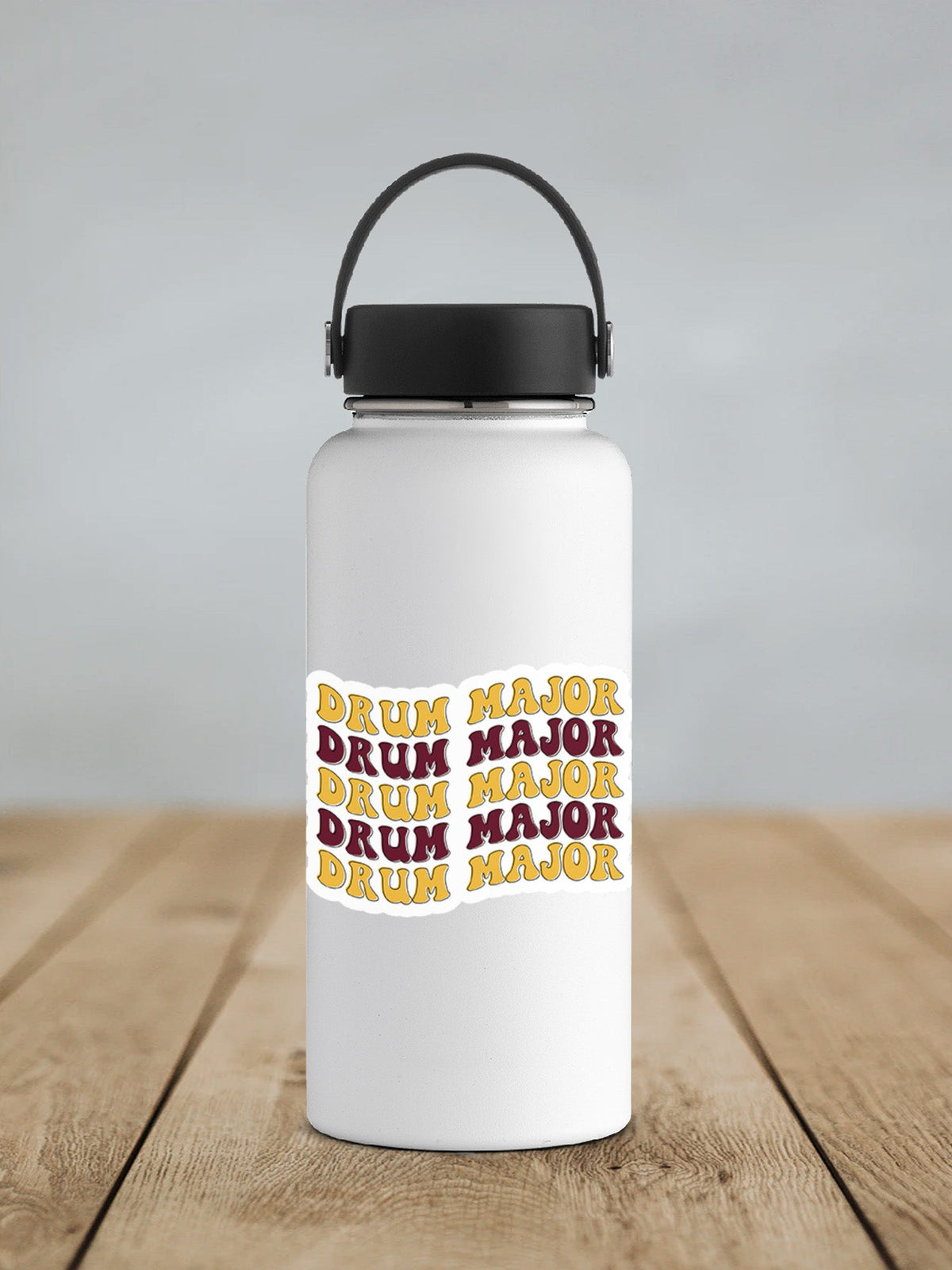 Maroon and Gold Drum Major sticker on a white insulated water bottle