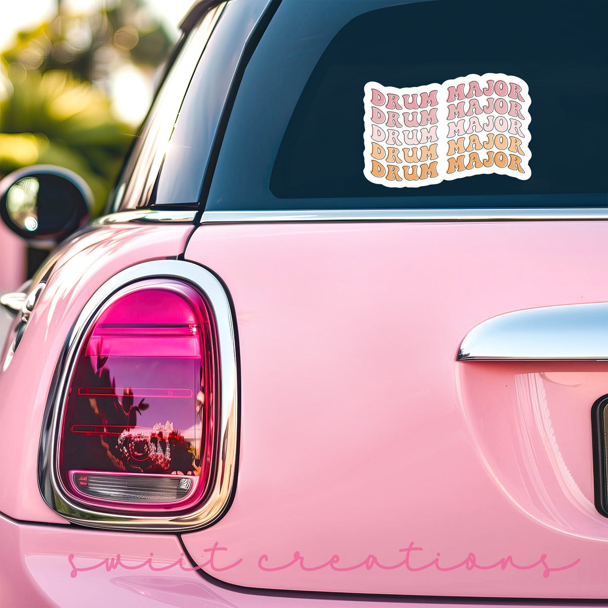 Retro Drum Major sticker on the back window of a pink car