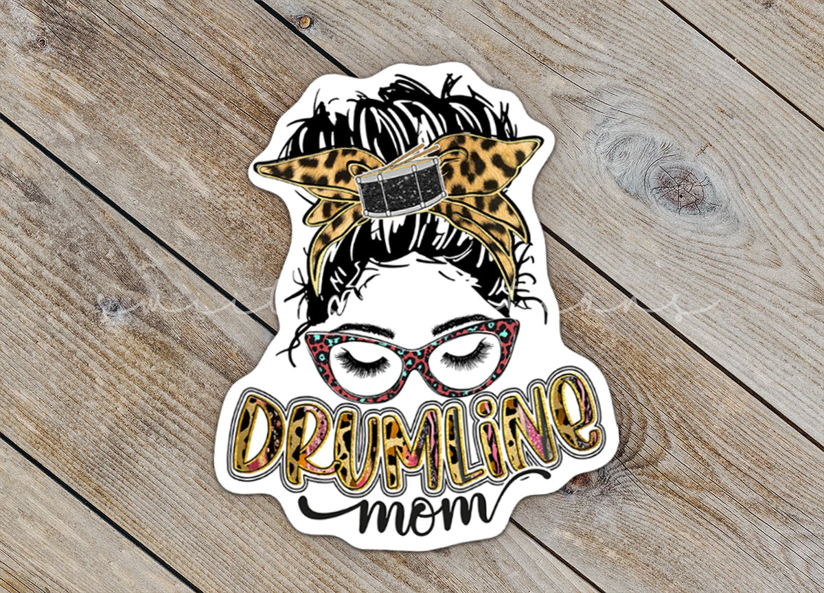 Close-up of the Drumline Mom sticker on rustic wood