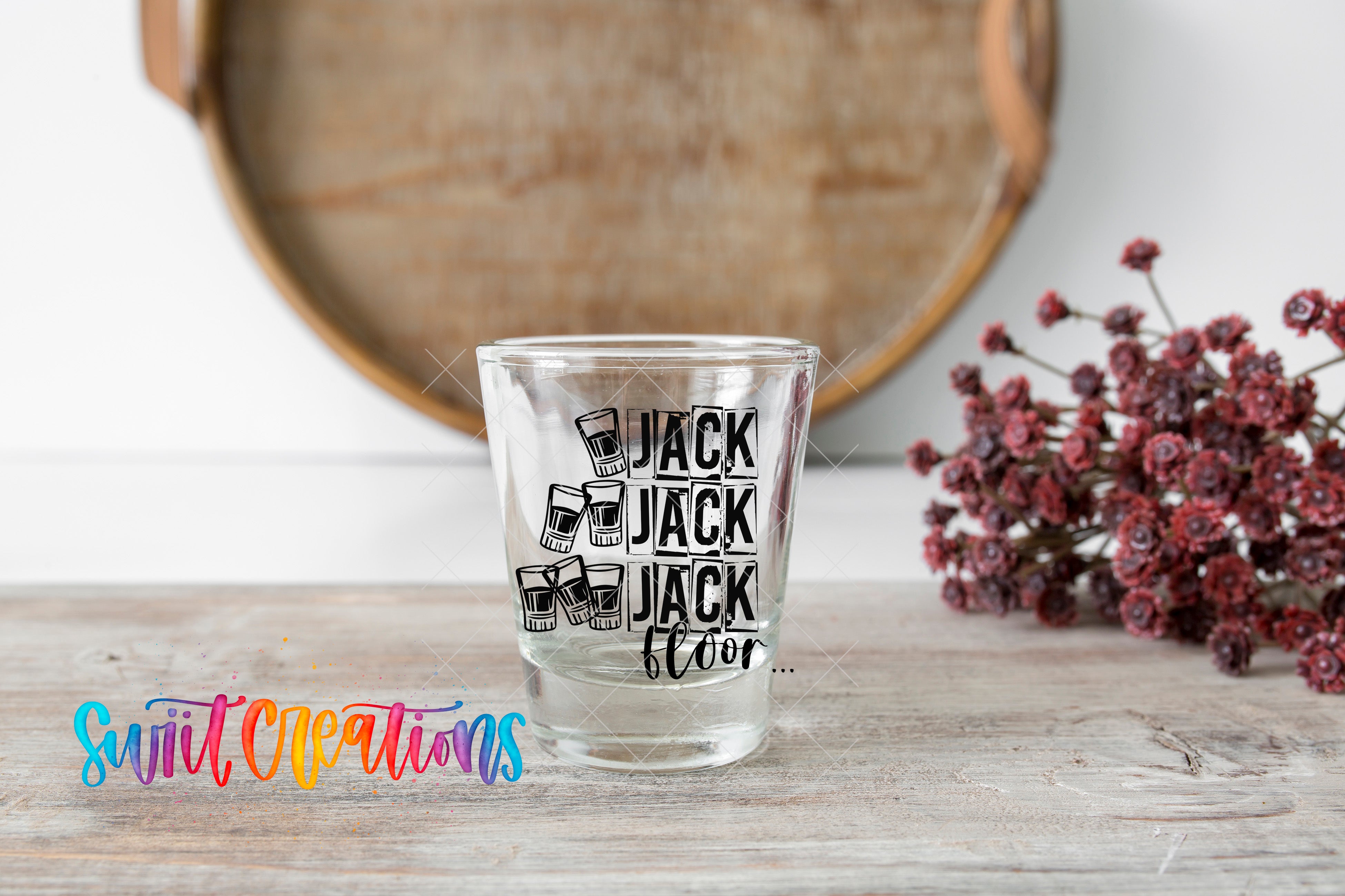 a shot glass sitting on top of a wooden table