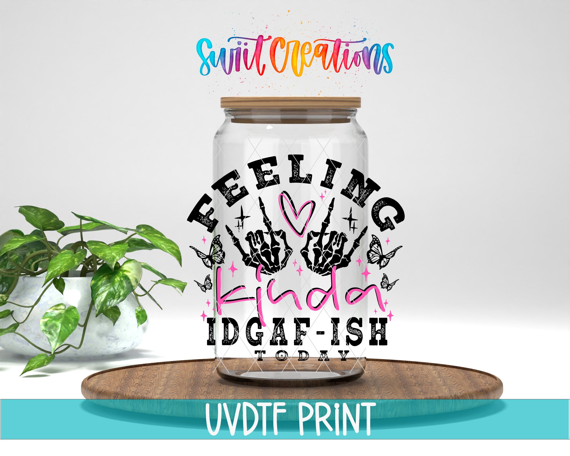 a clear glass jar with a hand-drawn design and text on it, placed on a wooden surface.