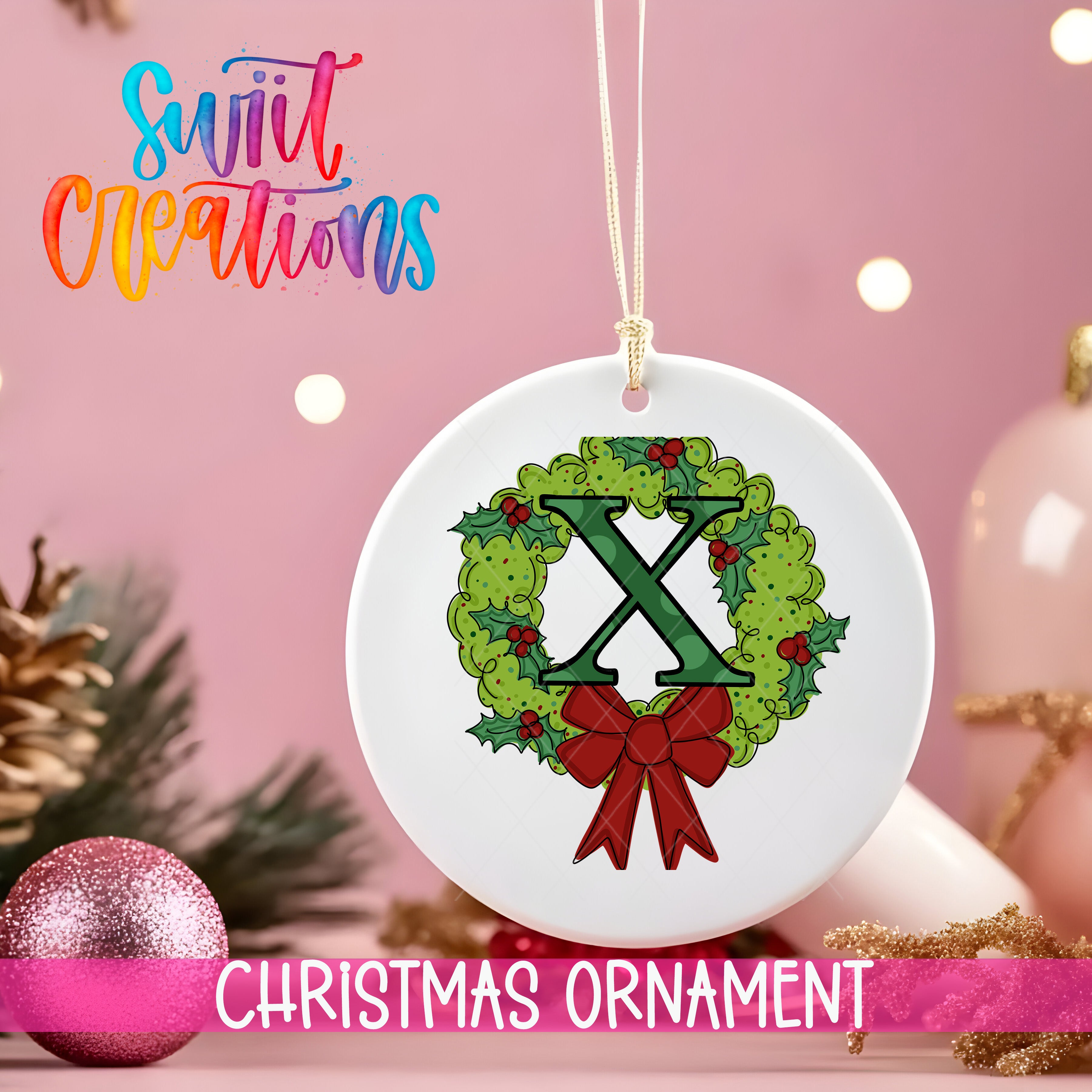 A white Christmas ornament with a green holly wreath and a red bow, hanging against a pink background with Christmas decorations and a pink glitter ball.