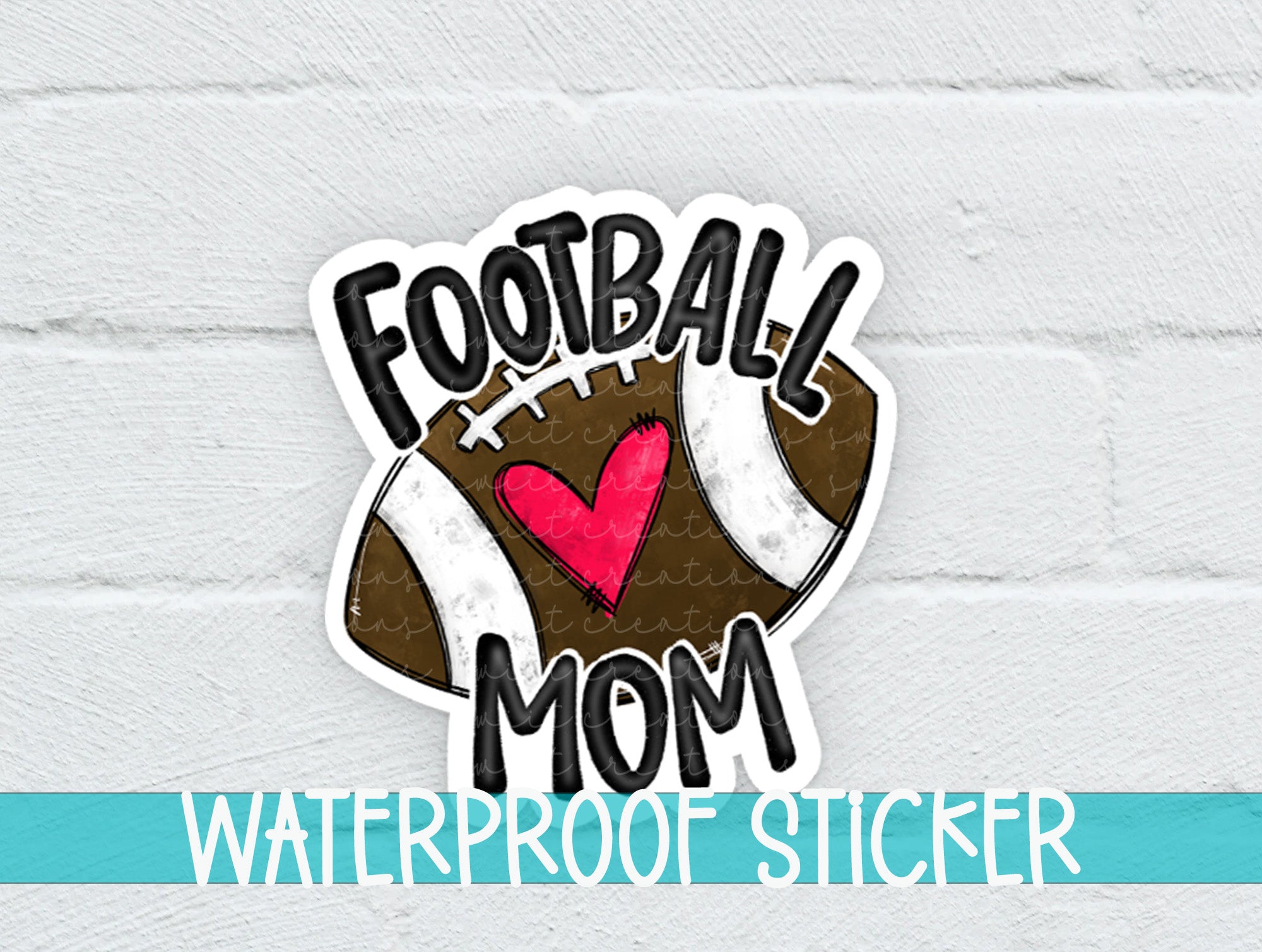 a football mom sticker on a white brick wall