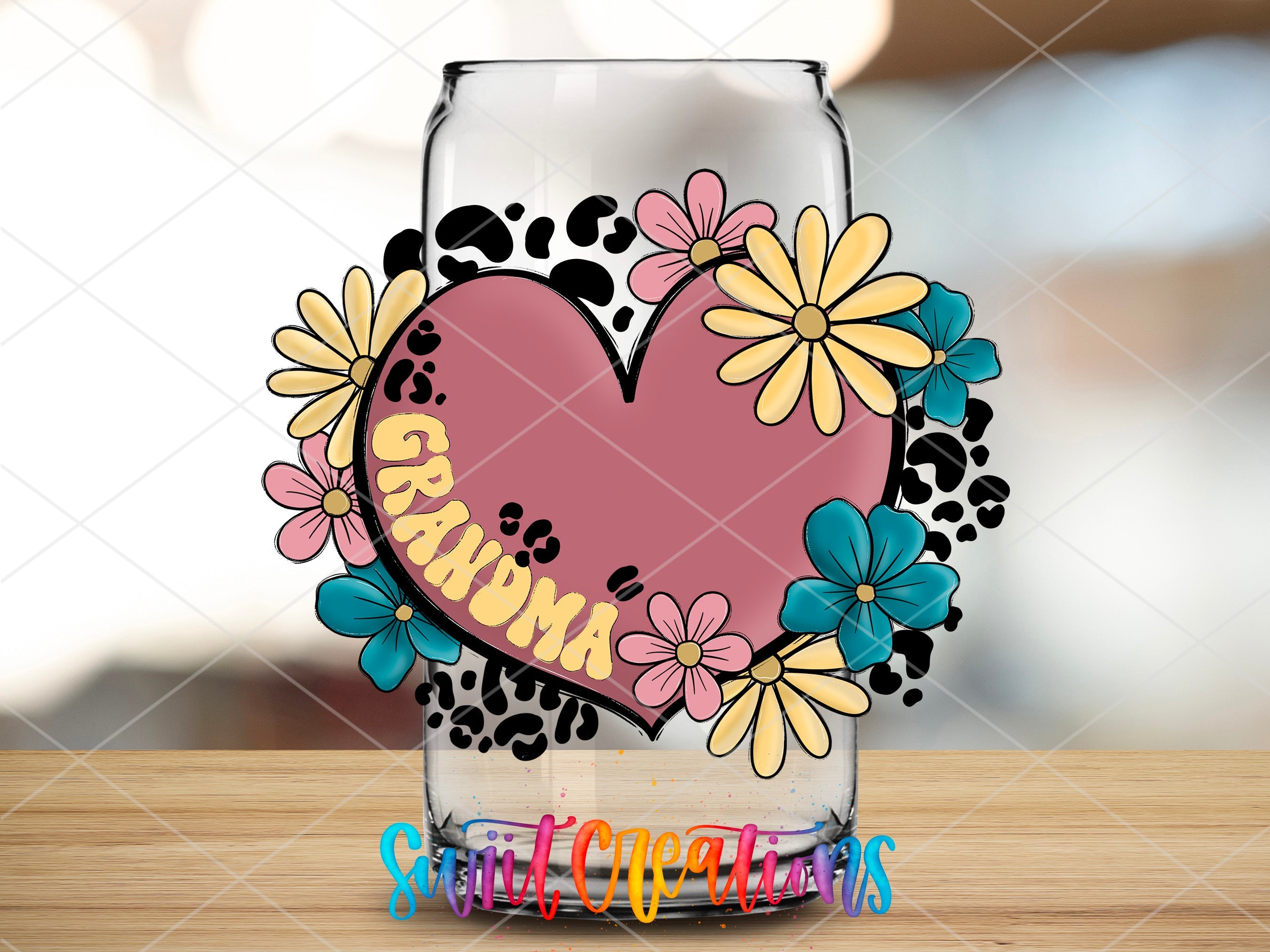 a glass with a heart and flowers on it