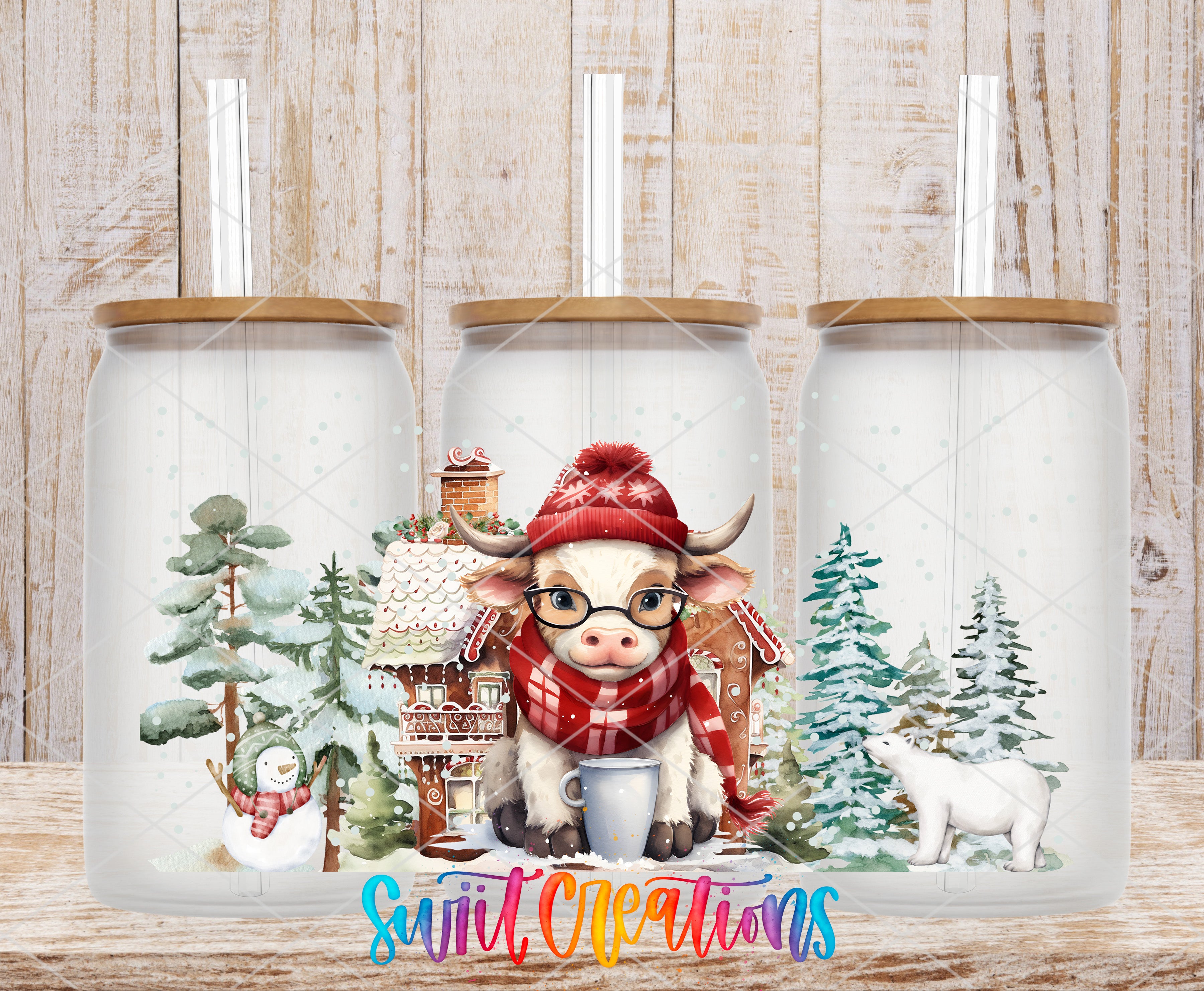 A cow wearing a red hat and scarf is sitting in a glass jar with a snowy winter scene, including a snowman, pine trees, and a gingerbread house.