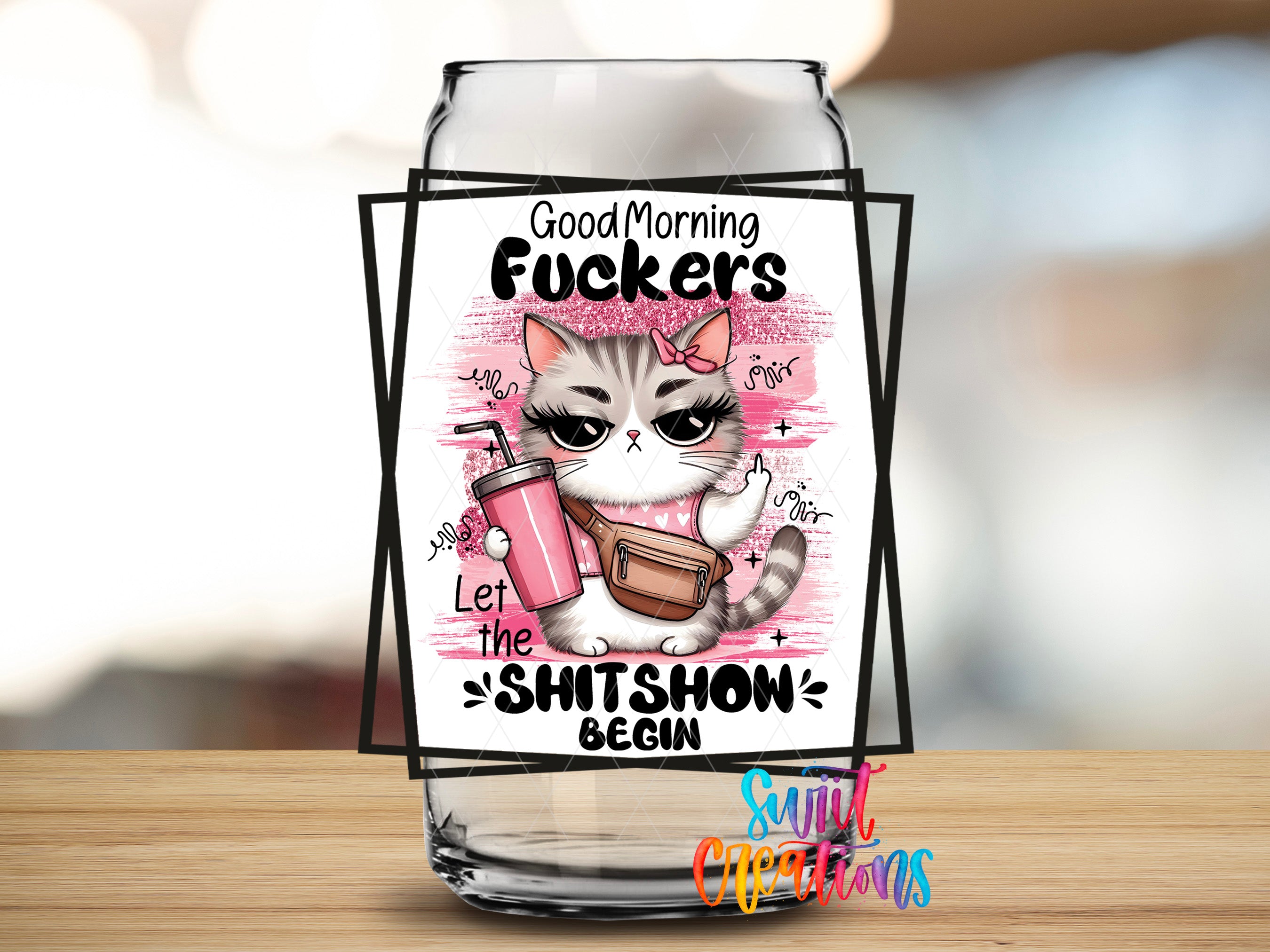 A glass jar with a label featuring a cartoon cat and text that says "Good Morning Fucks" and "Let the shitshow begin".