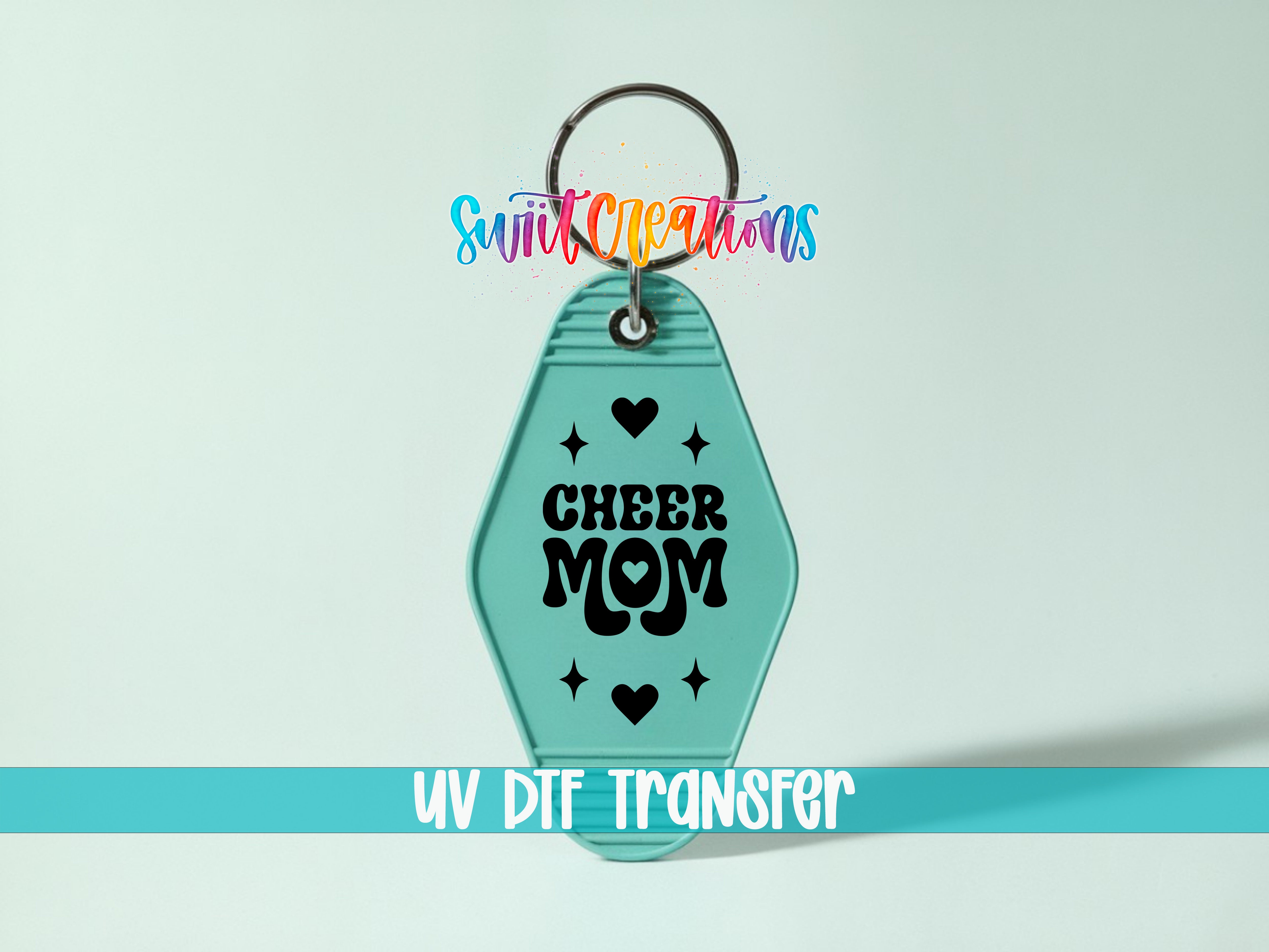 A keychain with a teal color and the text "CHEER MOM" printed on it.
