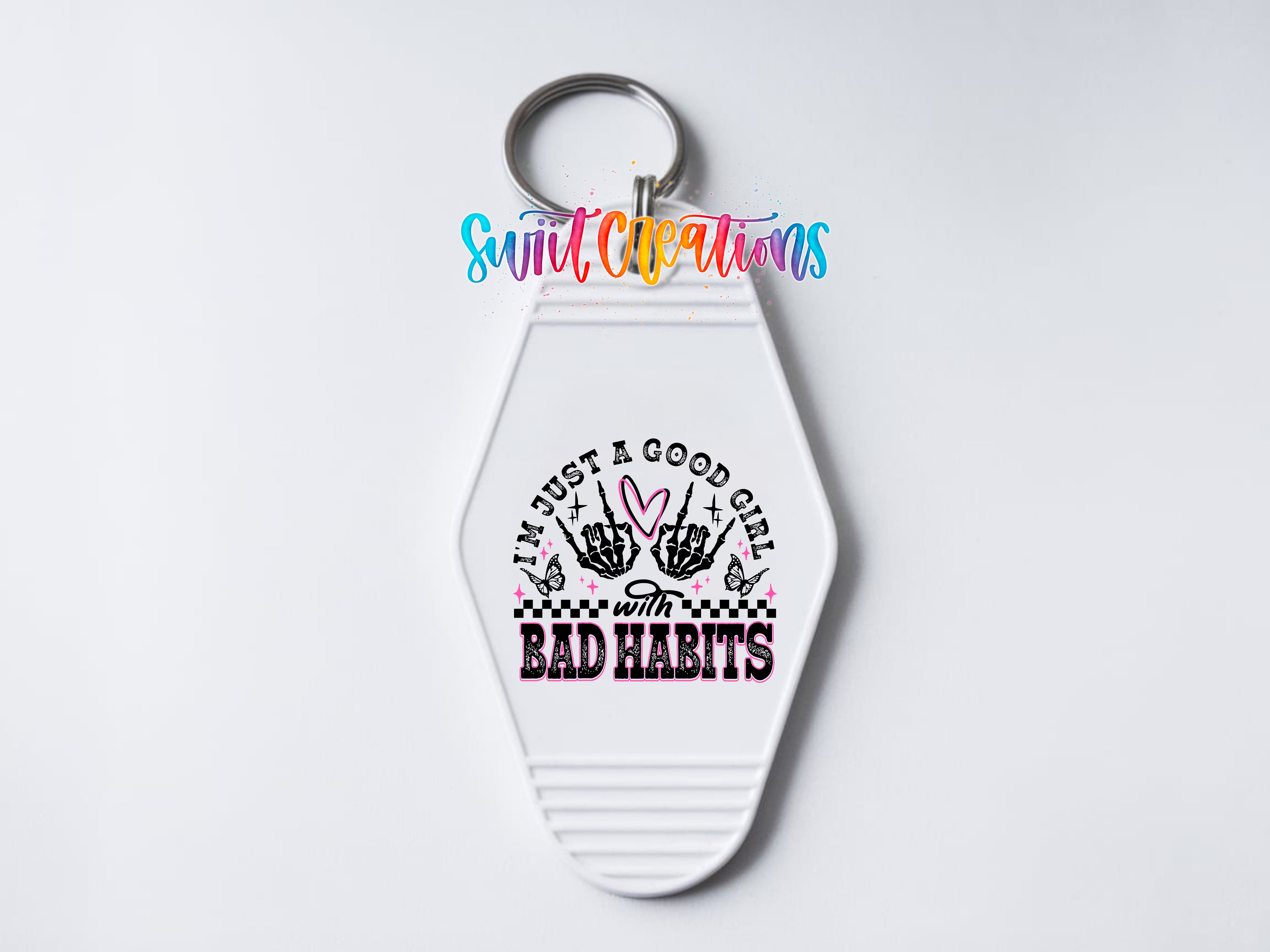 A keychain with a white hexagonal shape and a colorful design featuring text and graphics.