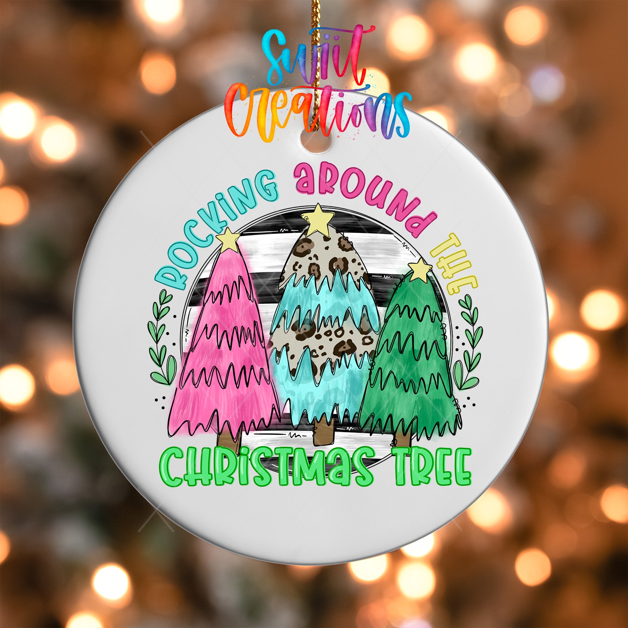A white Christmas tree ornament with colorful illustrations of three Christmas trees, along with the text "Rocking around the Christmas Tree".