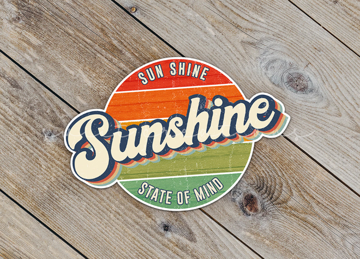 Close-up of the Sunshine State of Mind sticker on rustic wood