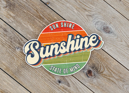 Close-up of the Sunshine State of Mind sticker on rustic wood