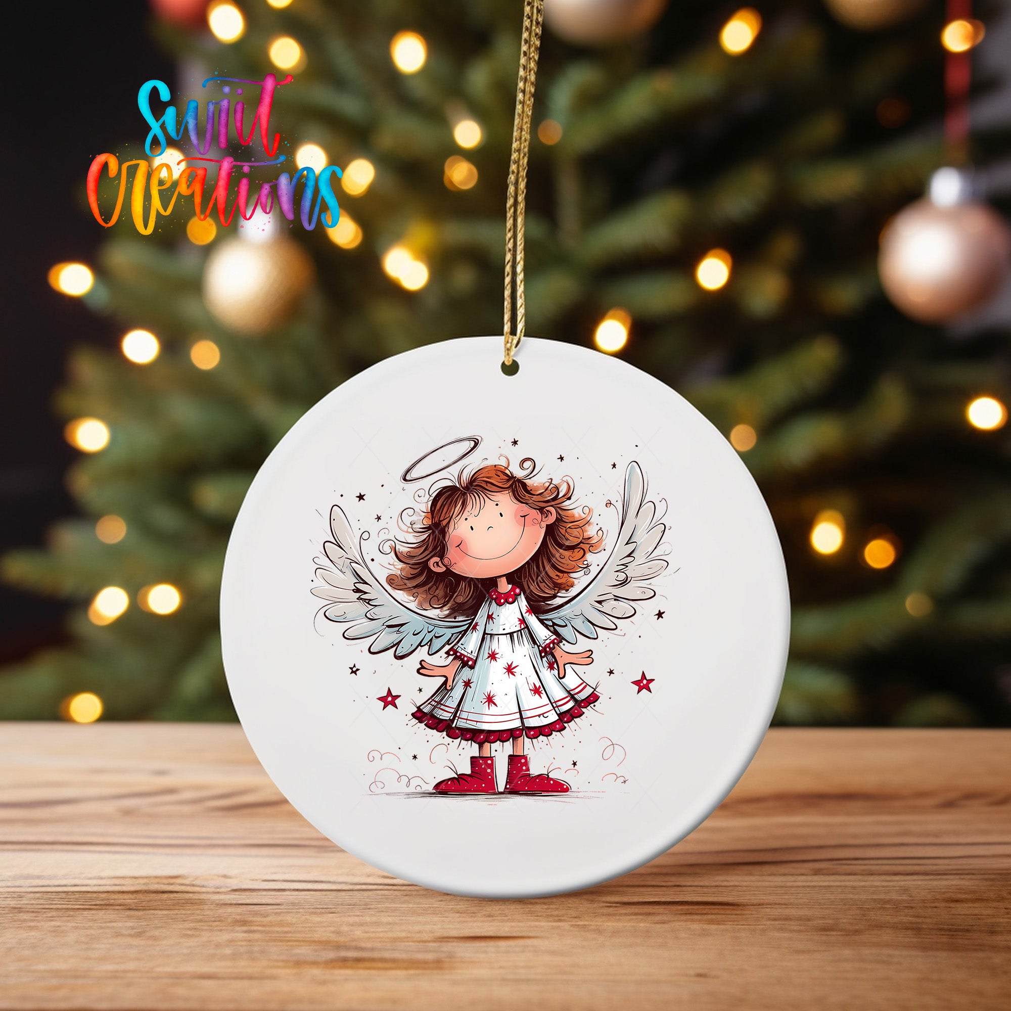 A white oval ornament featuring a cartoon illustration of a smiling girl with wings, standing in front of a Christmas tree with twinkling lights.